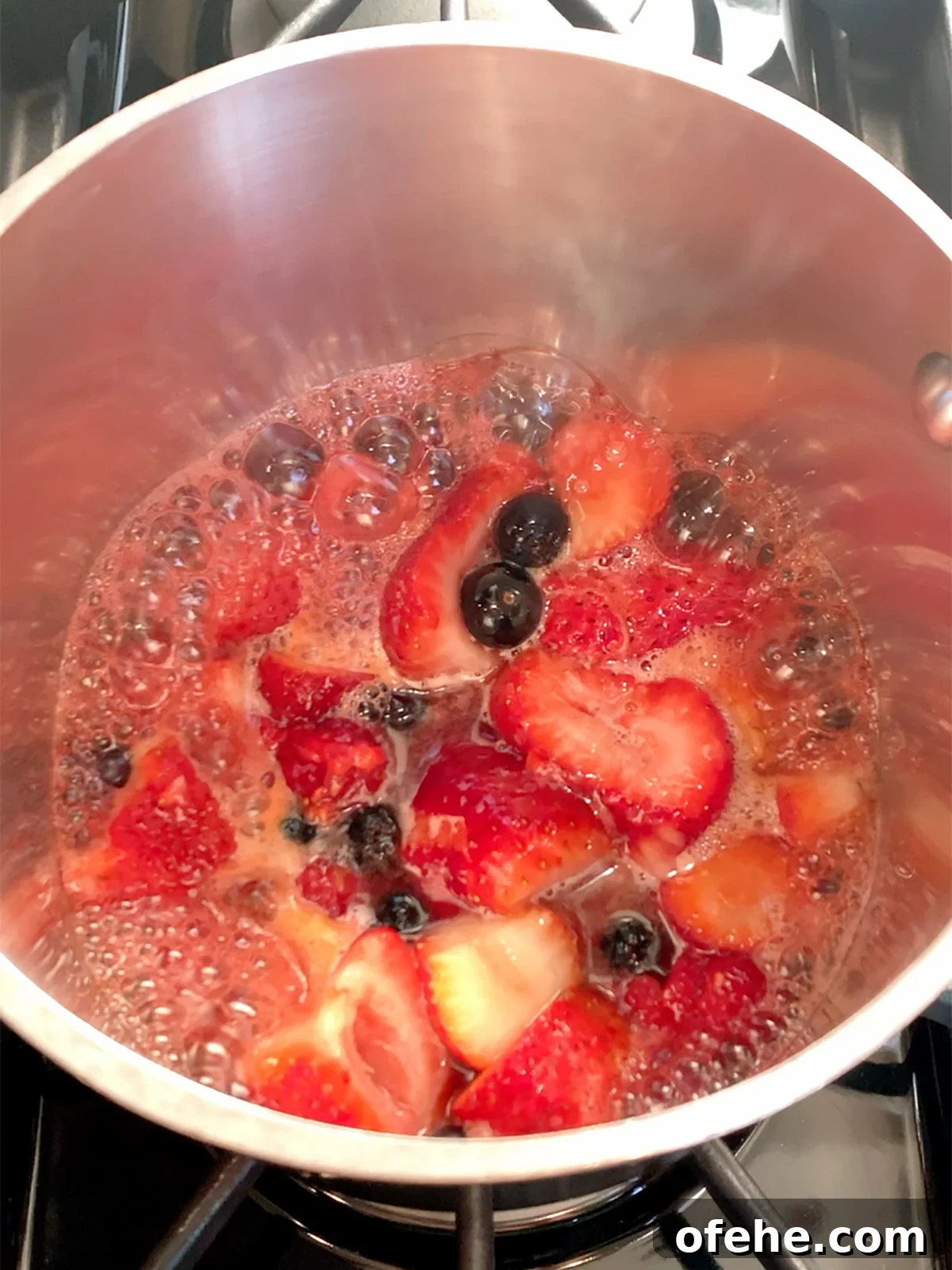 Fruit Compote Ideas: Delicious Pancake Toppers and More 7 Berry compote boiling in the pot on the stove.