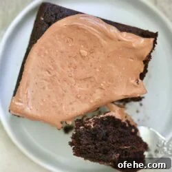 frosted cake with fork taking bite out.