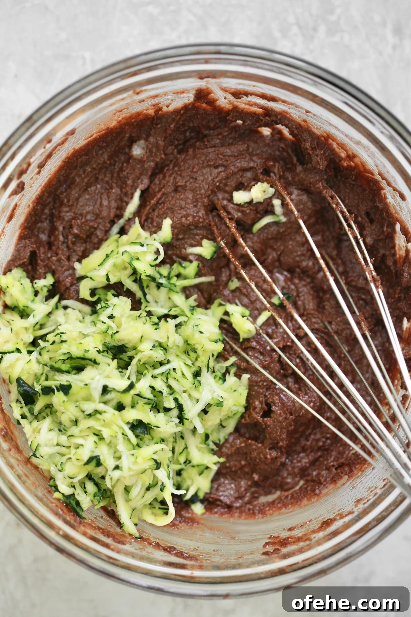 Decadent Chocolate Zucchini Cake That Actually Nourishes 5 brown batter with shredded zucchini.