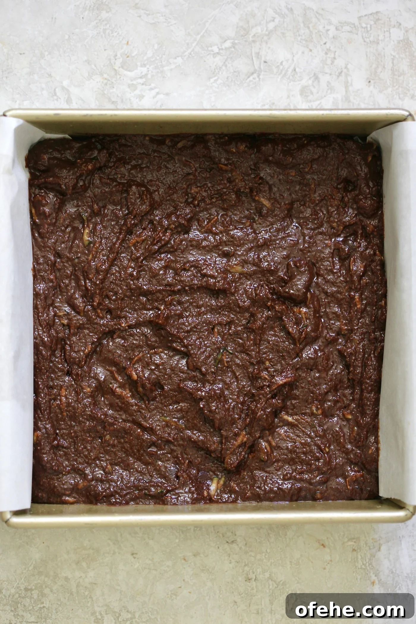 Decadent Chocolate Zucchini Cake That Actually Nourishes 6 unbaked chocolate cake in pan.