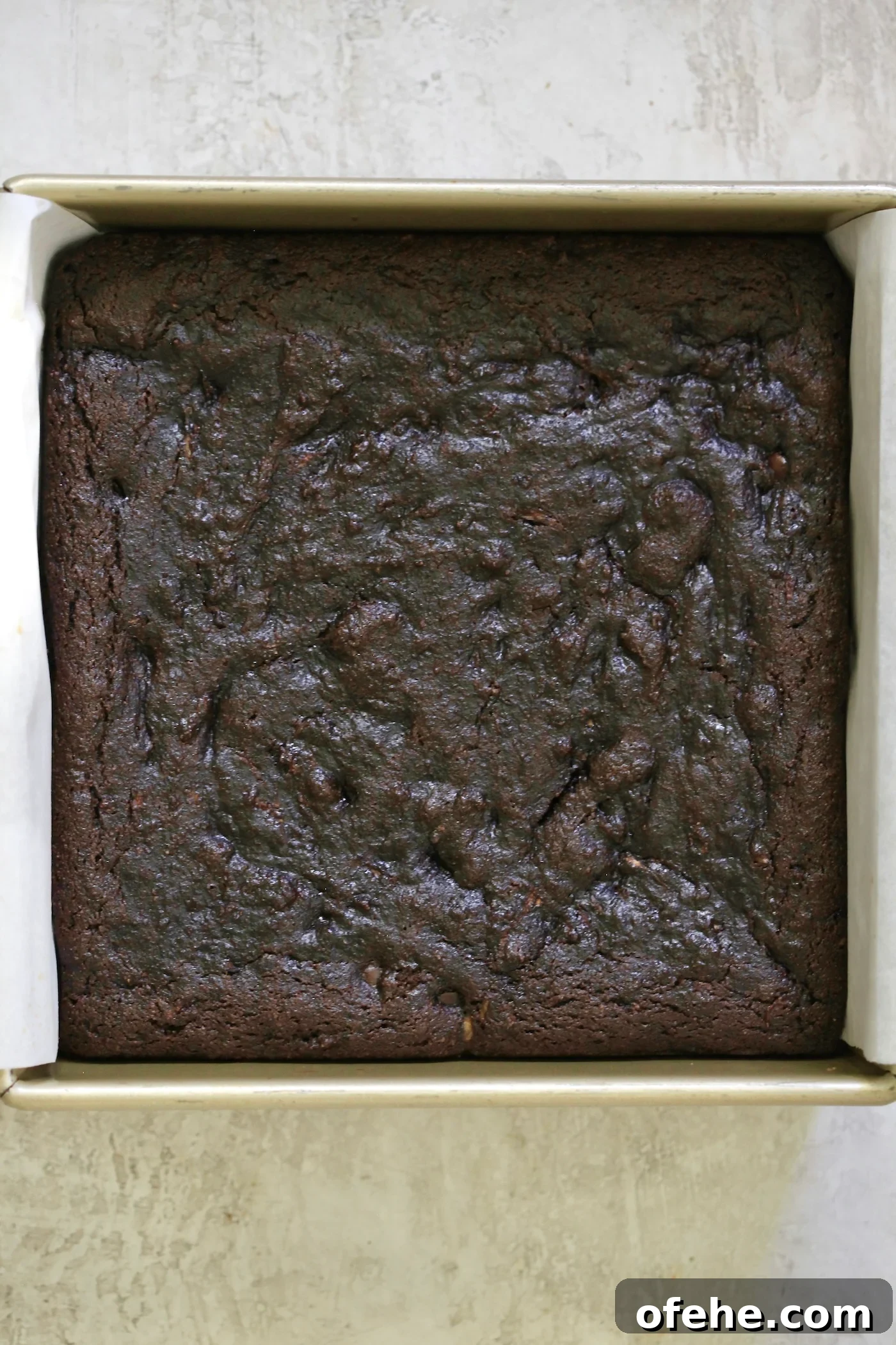 Decadent Chocolate Zucchini Cake That Actually Nourishes 7 baked chocolate cake in gold pan.