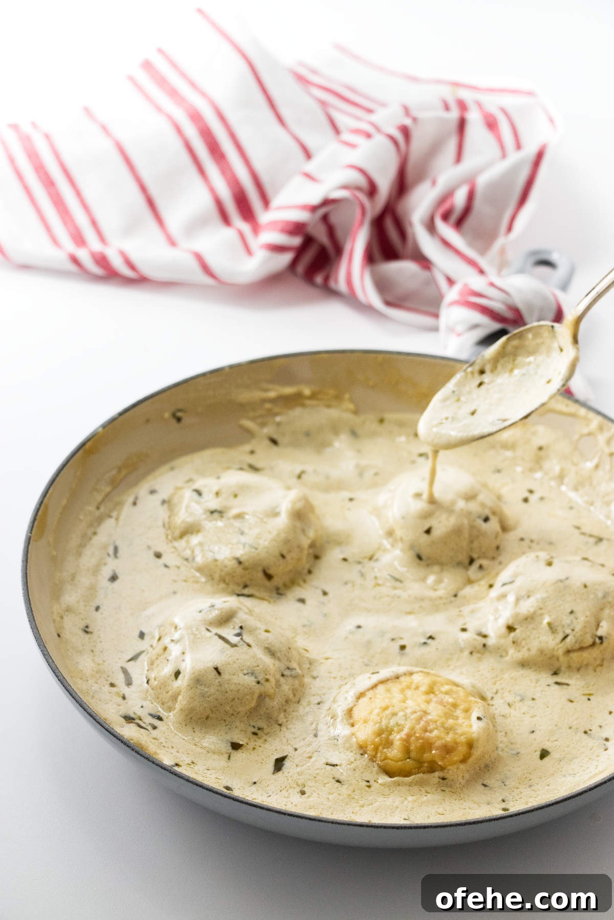 Lobster Ravioli Recipe: Creamy Sauce and Lemon Herb Tips 6 Drizzling cream sauce over ravioli.