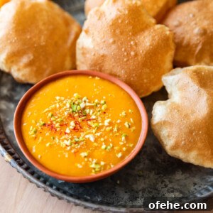Authentic Aam Ras Recipe: Creamy Mango Pulp for Indian Meals 4 picture of aam ras on a plate with many puris