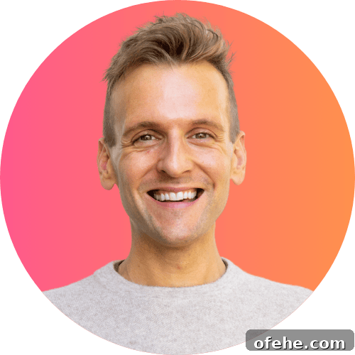 October 2023 Complete Guide: What You Need to Know This Month 2 Kaleb Wyse standing in front of ombre pink to orange background wearing taupe sweater.