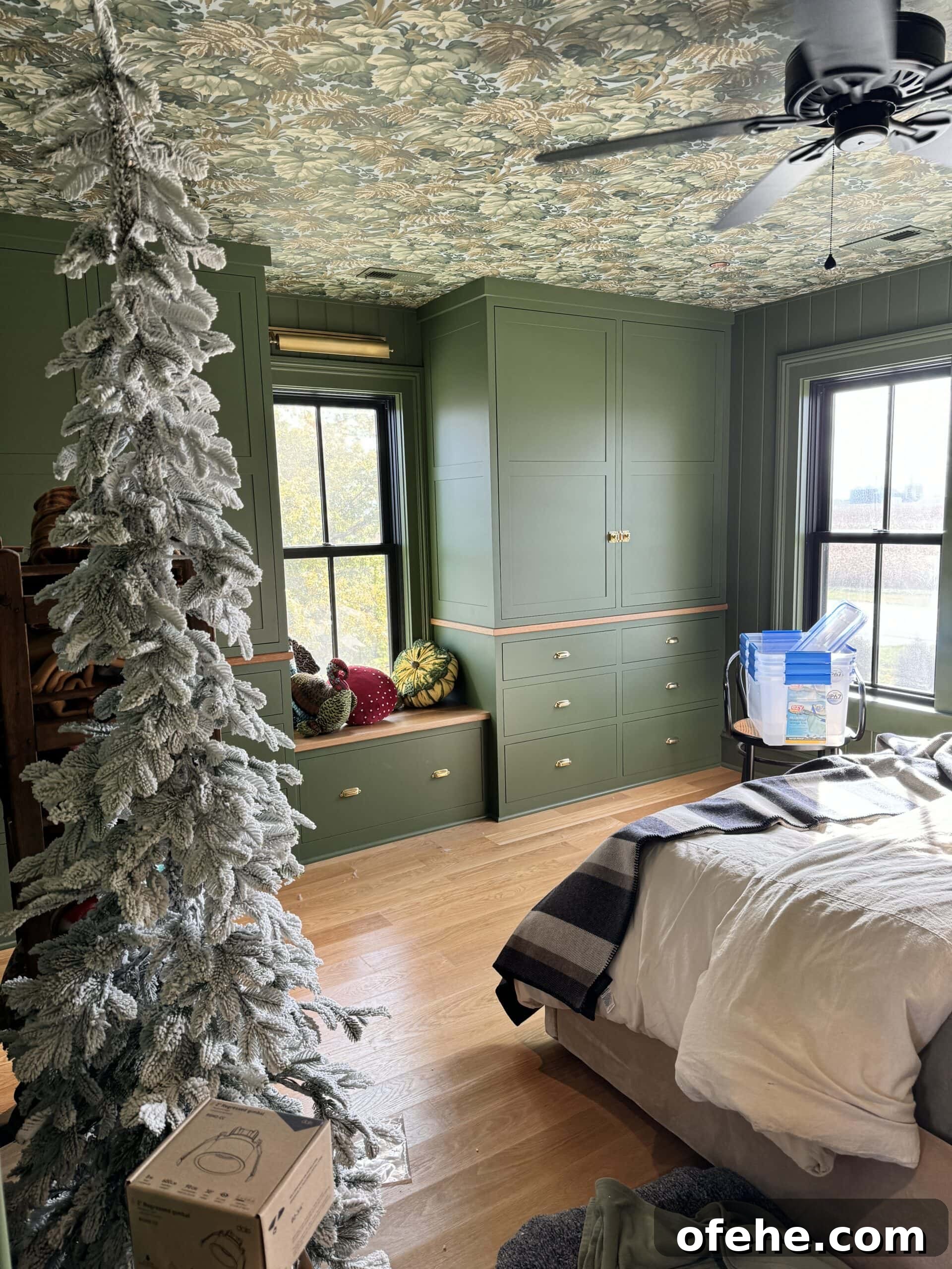 October 2023 Complete Guide: What You Need to Know This Month 5 Upstairs bedroom in all green with lots of boxes sitting around being decorated for the Christmas season.
