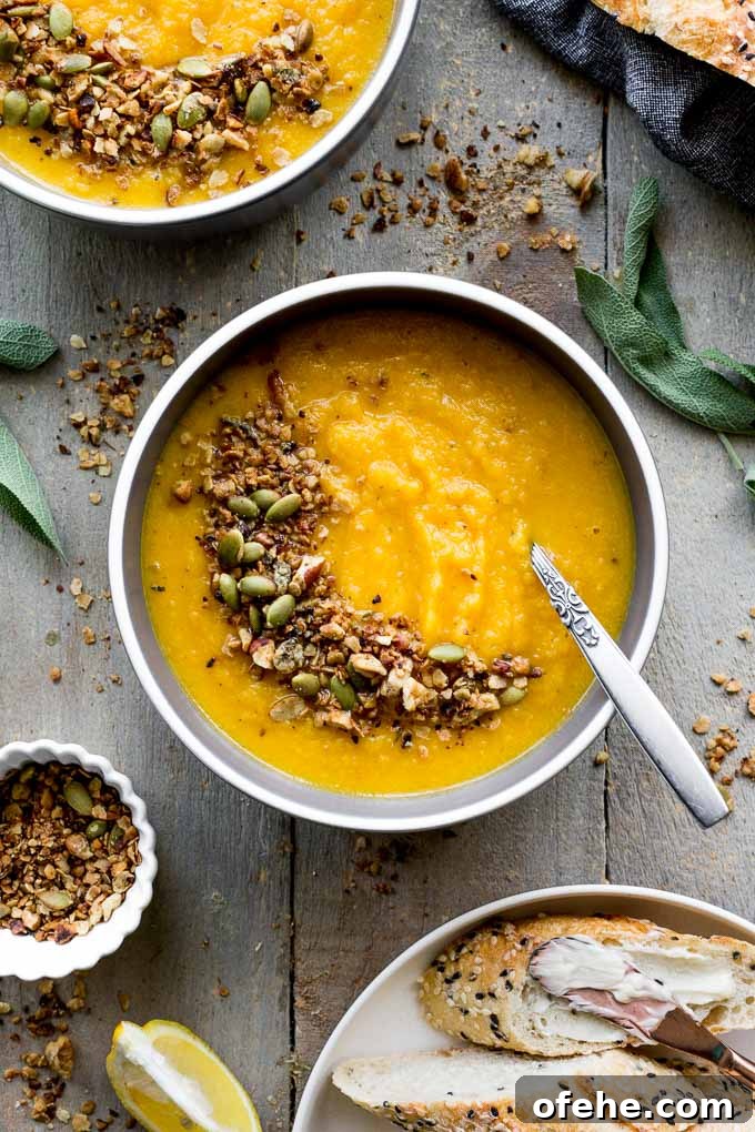 Golden Beet, Carrot & Ginger Soup — Vegan Recipe Guide 2 Overhead view of bowls of golden beet soup on a wooden surface.