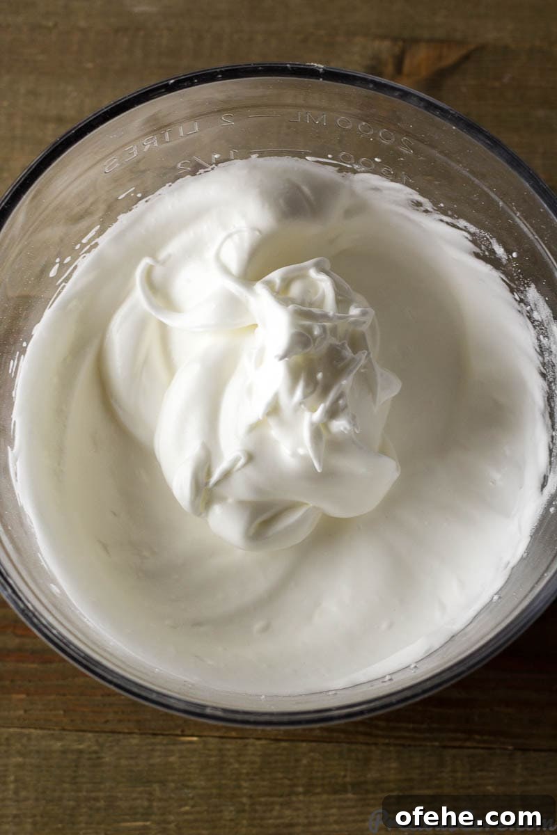 Classic Vanilla Sponge Cake Recipe for Light, Fluffy Layers 4 Glass bowl of whipped egg whites.