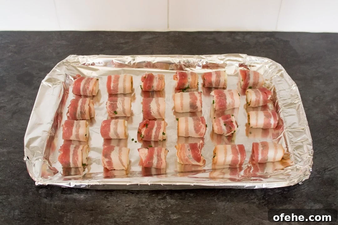Crispy Bacon-Wrapped Halloumi Bites Recipe 5 uncooked Bacon Halloumi Bites on a bacon tray