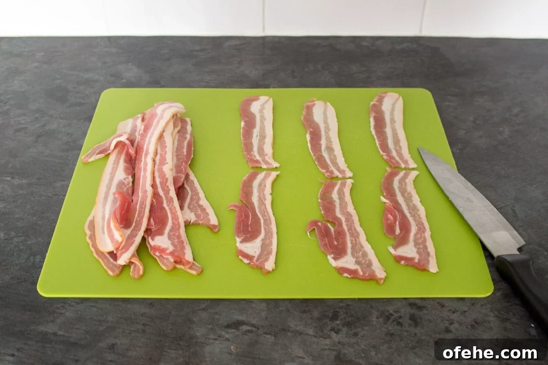 Crispy Bacon-Wrapped Halloumi Bites Recipe 3 Bacon Halloumi Bites: bacon rashers on a chopping board