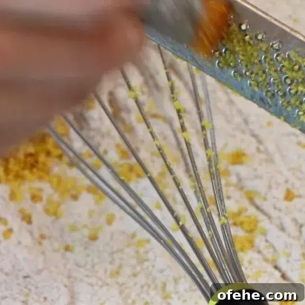 zesting lemon over dry ingredients
