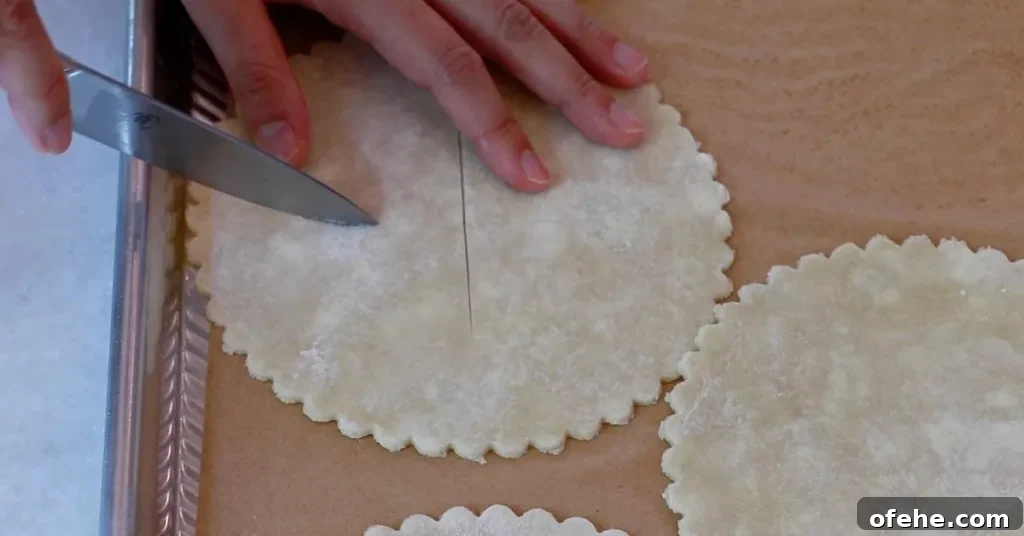 cutting the surface of pie dough for blueberry pies