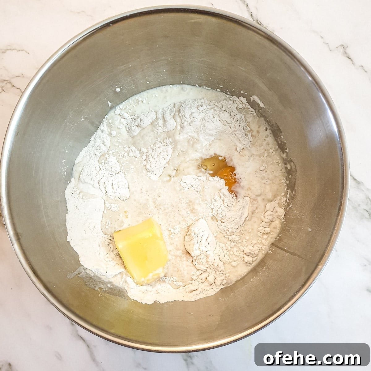 Homemade Chelsea Buns: Soft Cinnamon-Spiced Sticky Buns 8 Melted butter and milk added to the flour with an egg.
