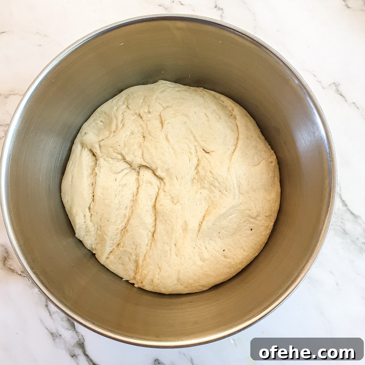 Homemade Chelsea Buns: Soft Cinnamon-Spiced Sticky Buns 10 A ball of dough that has rested and doubled in size.