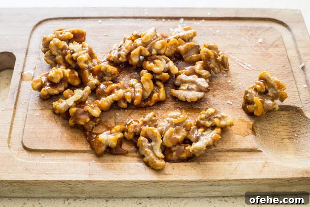 caramelised walnuts cooling on a wooden board