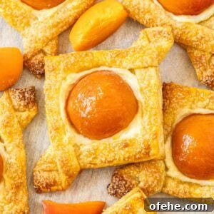 Apricot Cream Cheese Puff Pastry Tart Recipe 12 Baked Apricot and Cream Cheese Pastries on some baking paper.