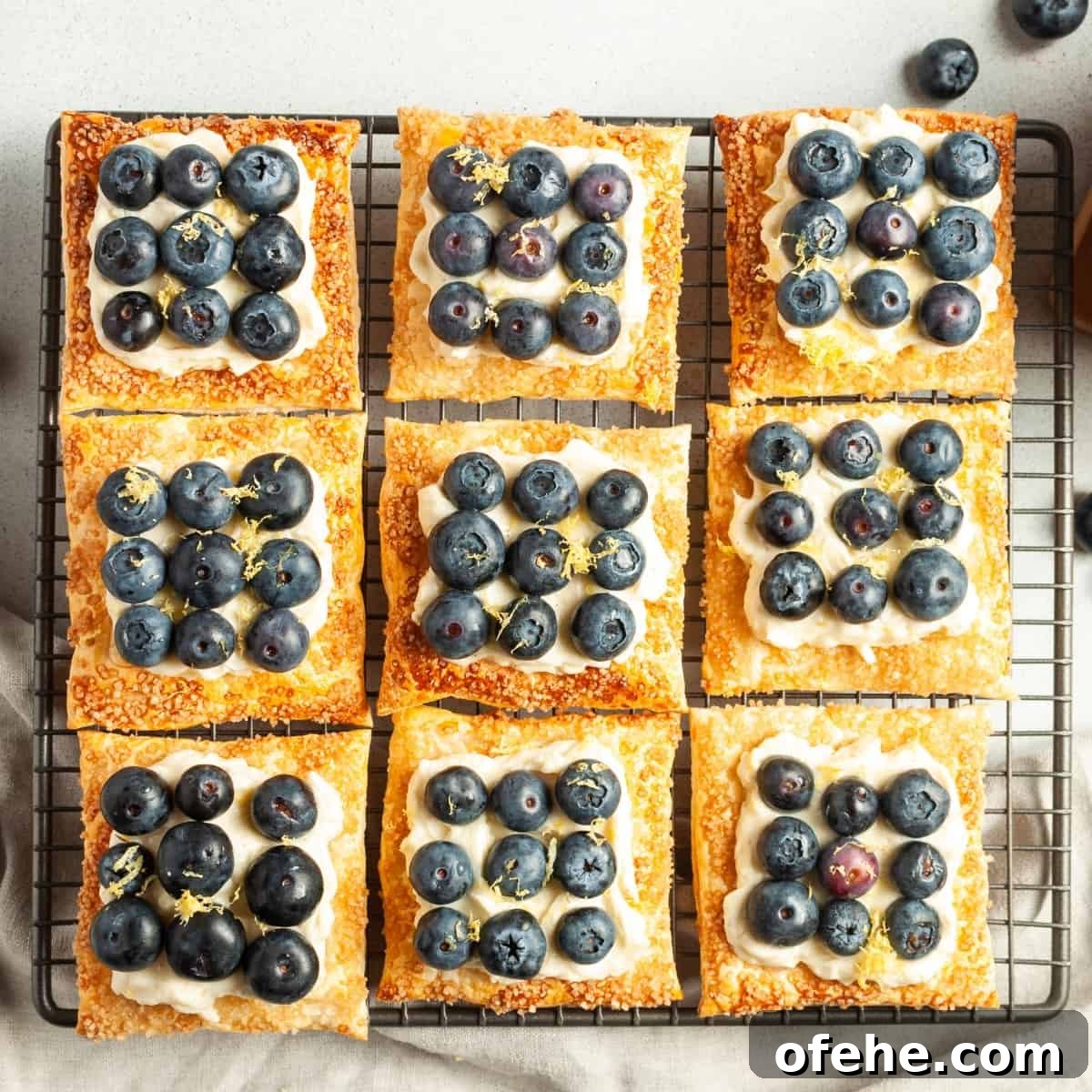 9 tartlets assembled and sitting on a cooling tray.