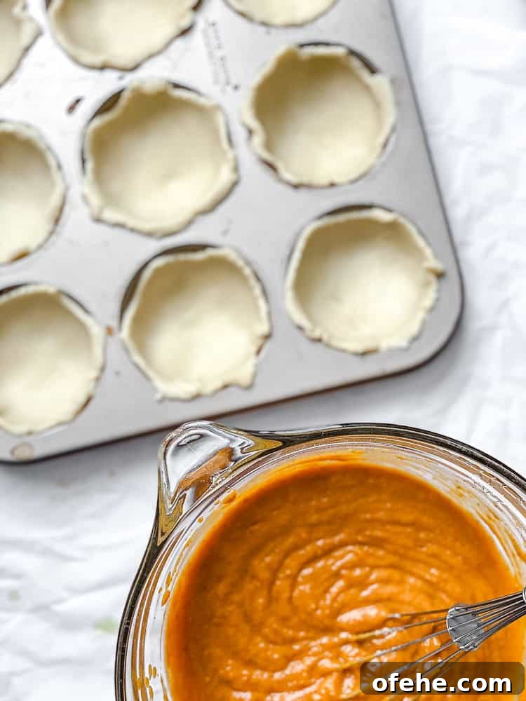 Mini Pumpkin Pie Recipe: Perfect Individual Fall Desserts 5 process shot showing pie crust in muffin tin