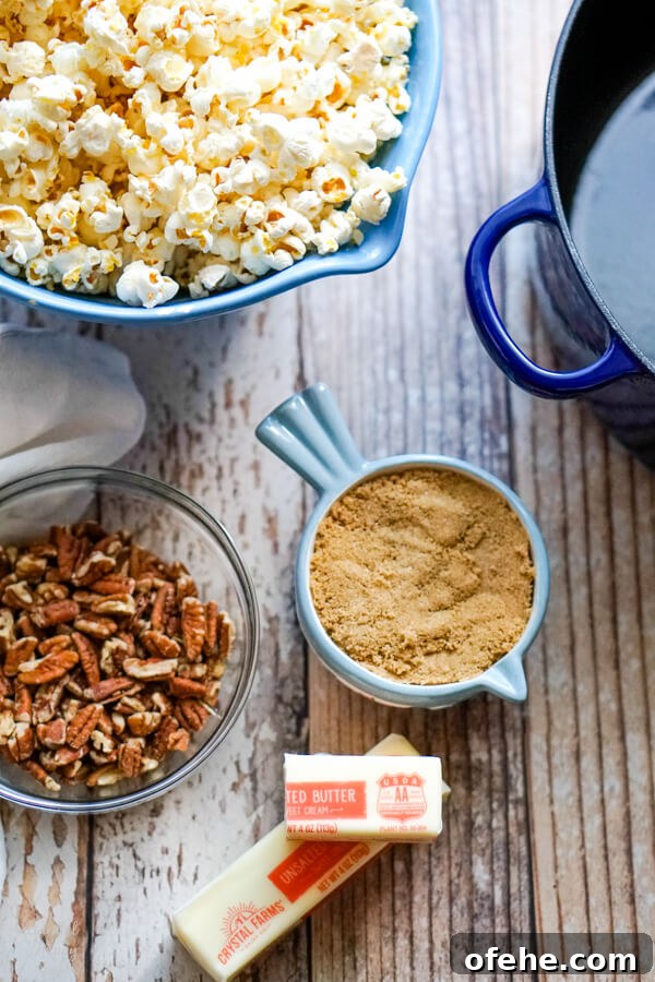 Salted Caramel Pecan Popcorn Recipe — Sweet & Crunchy Snack 4 A bowl of popped popcorn next to pecans, brown sugar, and butter.