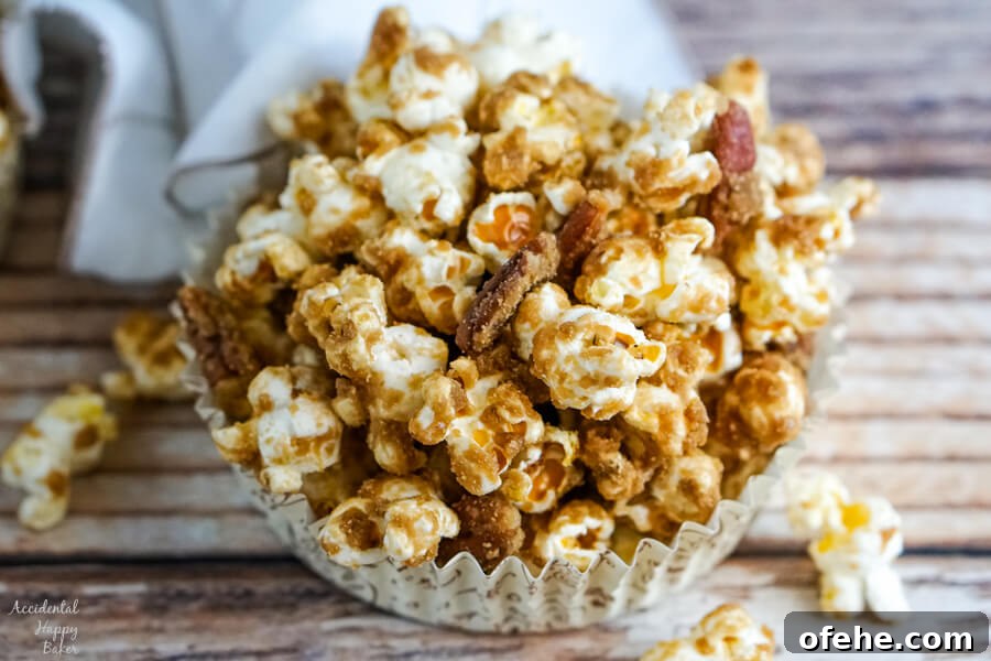A paper cup with a serving of Salted Caramel Pecan Popcorn