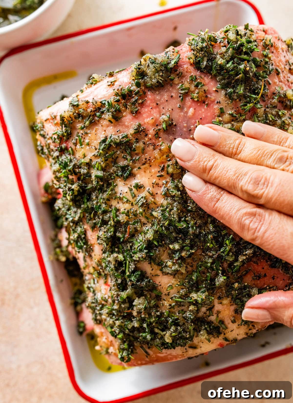Garlic Herb Crusted Prime Rib Rub: Savory Seasoning Blend 9 hand rubbing the herb rub on the standing prime rib roast.