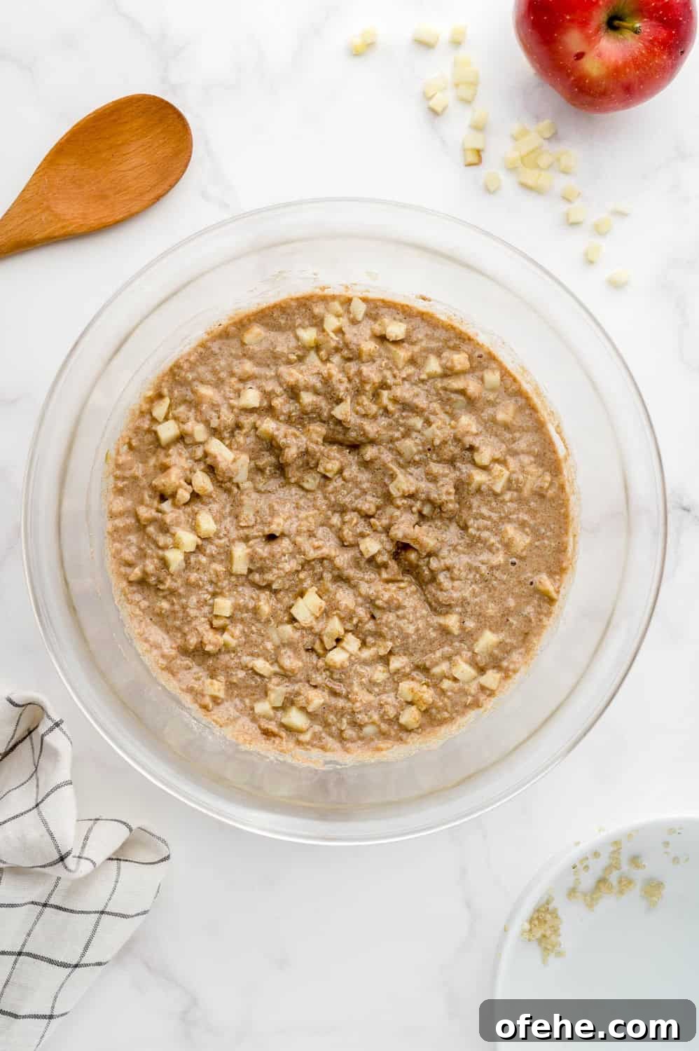 Apple Quinoa Pancakes That Crisp Up Perfectly 11 Completed pancake batter in a clear glass mixing bowl.