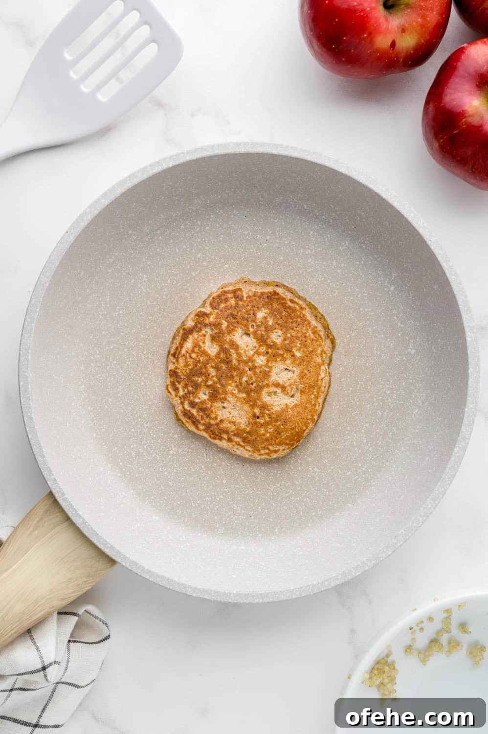 Apple Quinoa Pancakes That Crisp Up Perfectly 13 Cooked pancake in skillet.