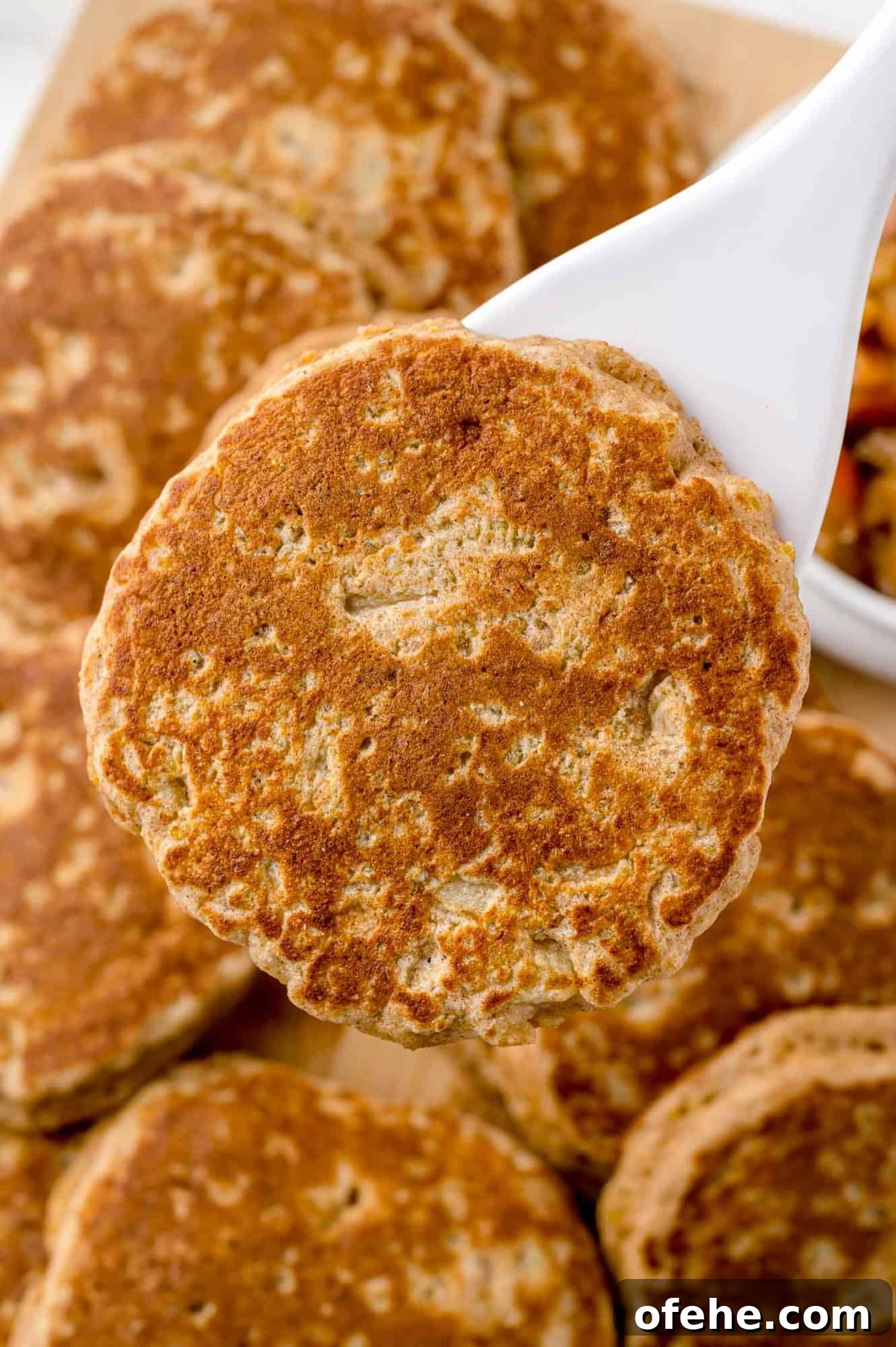 Apple Quinoa Pancakes That Crisp Up Perfectly 14 Pancake on a spatula.