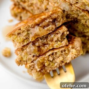 Apple Quinoa Pancakes That Crisp Up Perfectly 15 Apple quinoa pancakes on a fork with syrup.