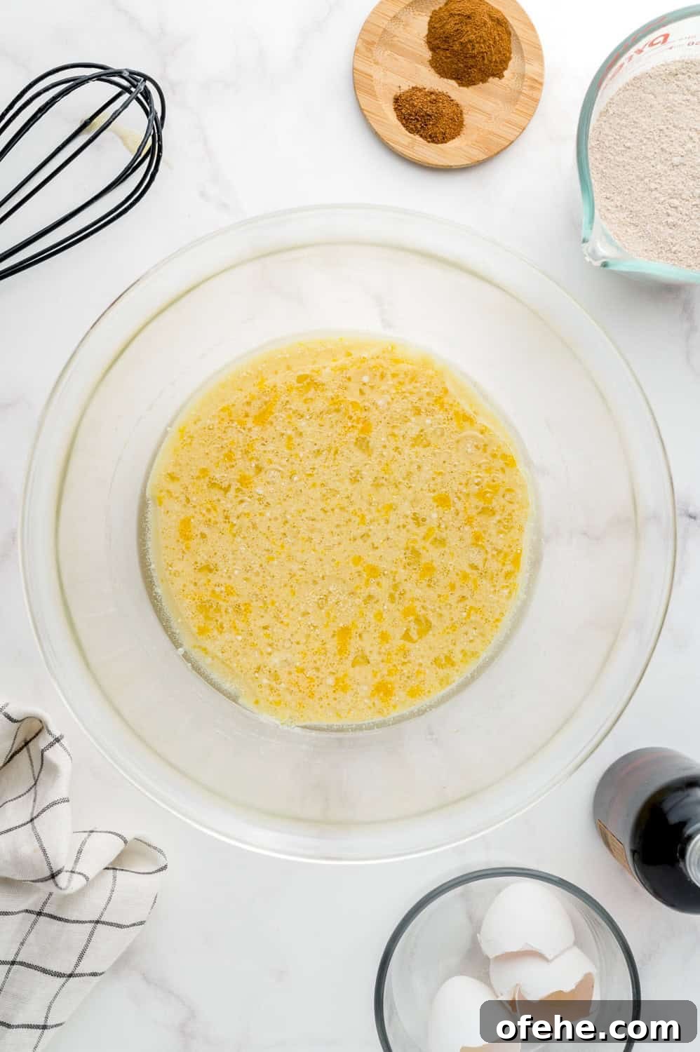 Apple Quinoa Pancakes That Crisp Up Perfectly 6 Wet ingredients mixed in a clear glass mixing bowl.