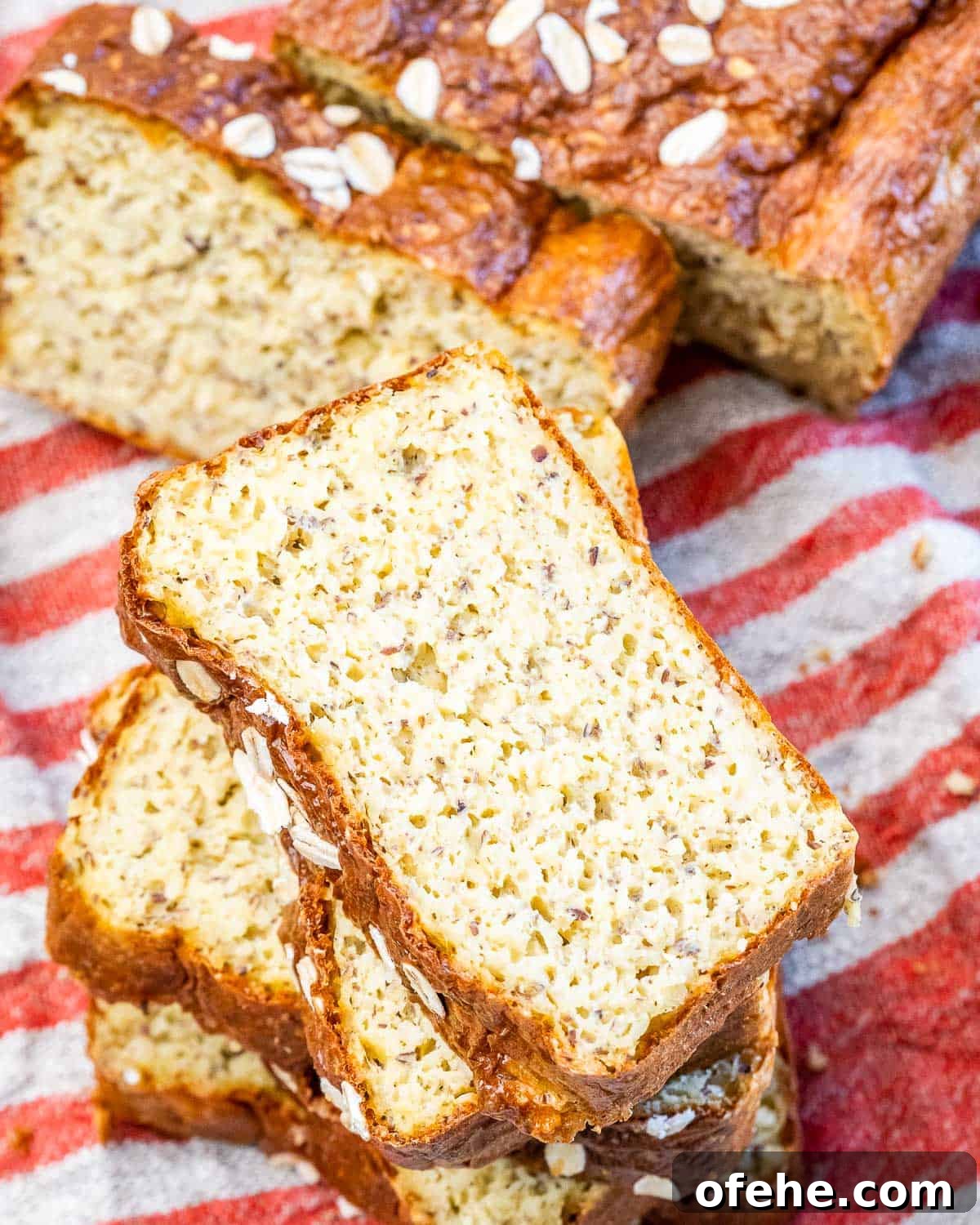 Cottage Cheese Loaf Recipe: Soft, Tangy Homemade Bread 3 slices of fresh baked bread over a red and white towel.