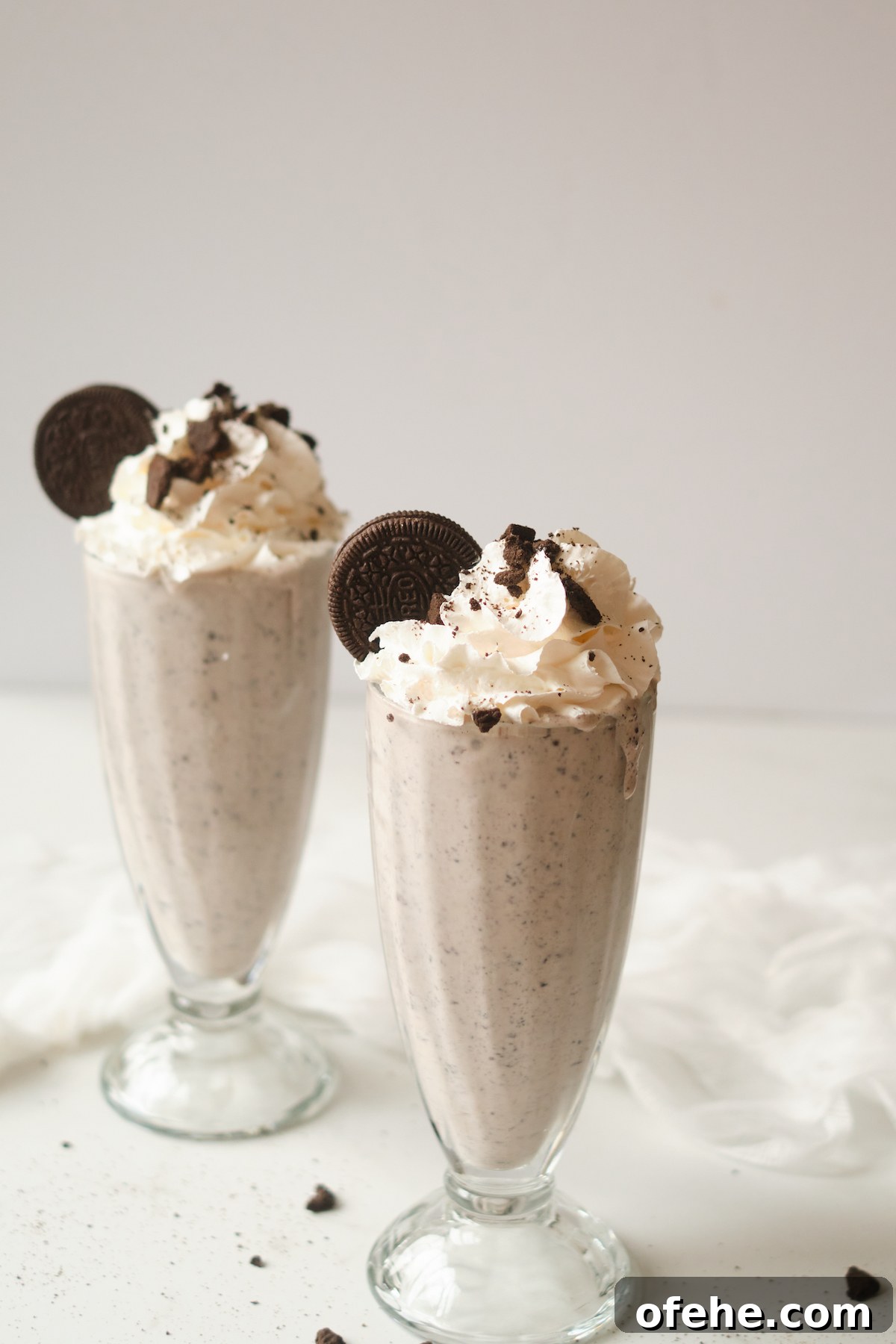 Oreo Milkshake Recipe: How to Make It with a Ninja Creami 5 two glasses filled with oreo cookie milkshake