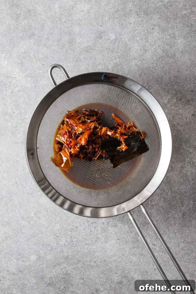 Kombu kelp and bonito flakes in a mesh sieve to strain off the mentsuyu.