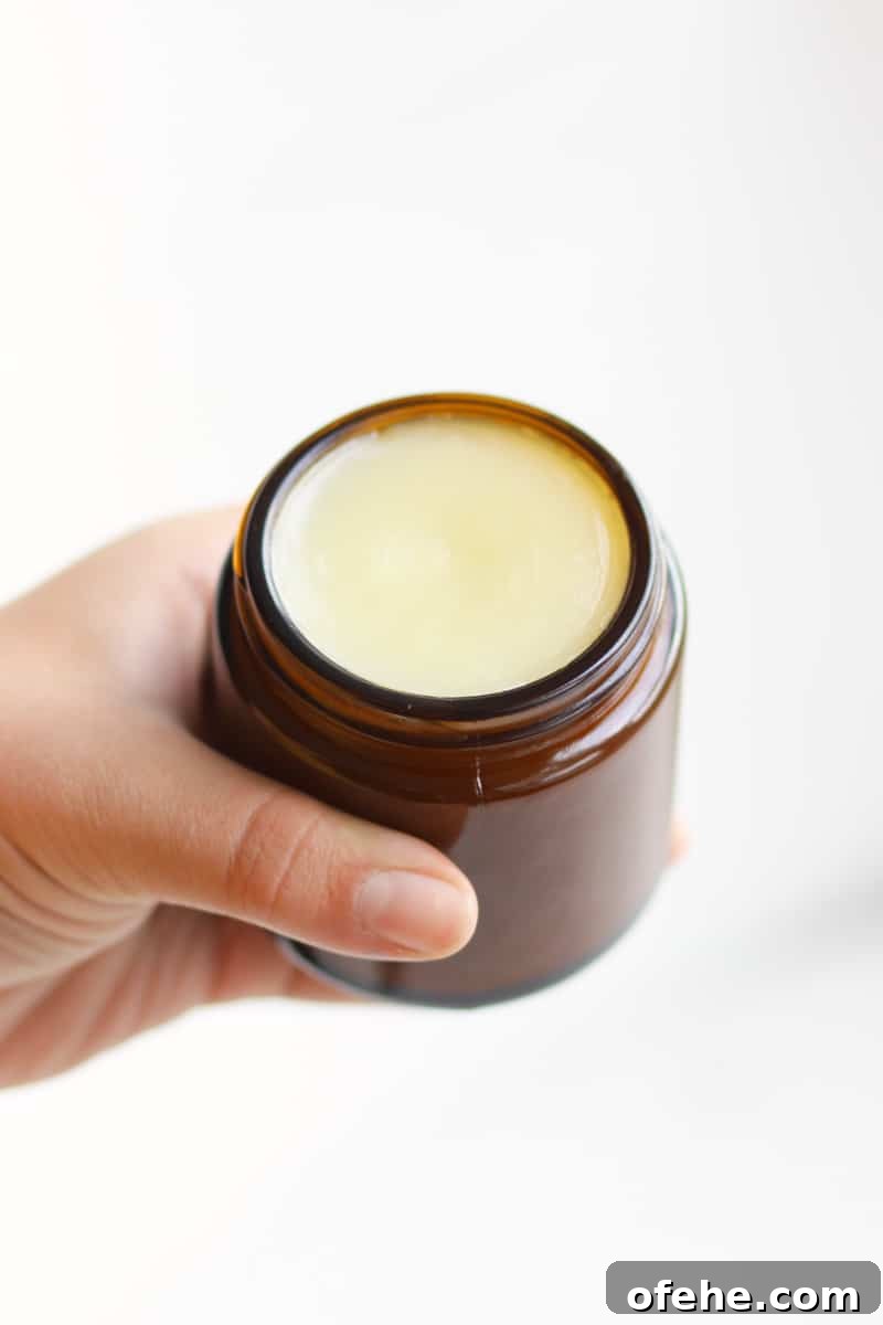 DIY Natural Vapor Rub with Essential Oils for Congestion Relief 2 an amber glass jar with homemade vapor rub in it