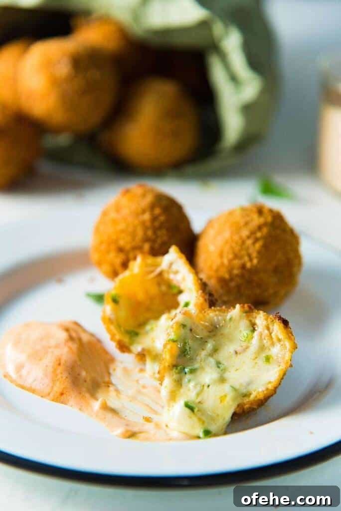 jalapeno fritters on a plate dipped into sauce.