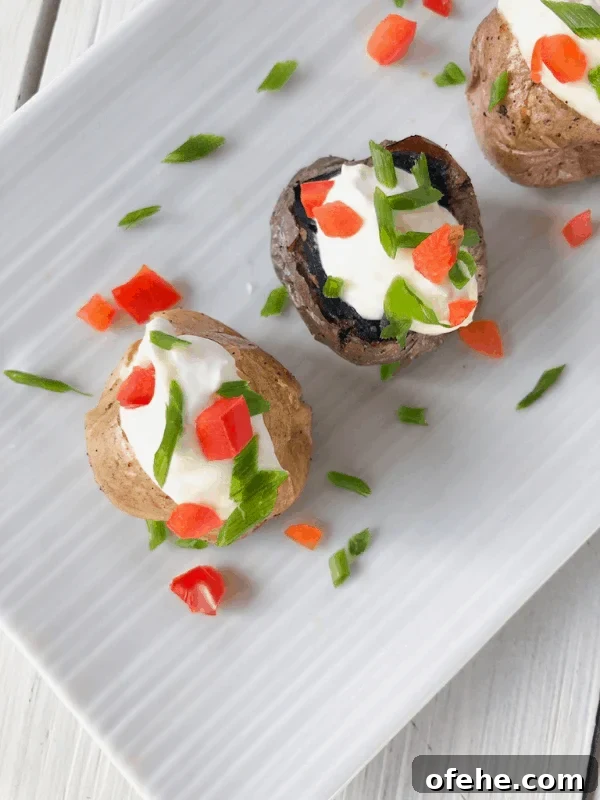 Mini baked potatoes with sour cream and cheese in the middle
