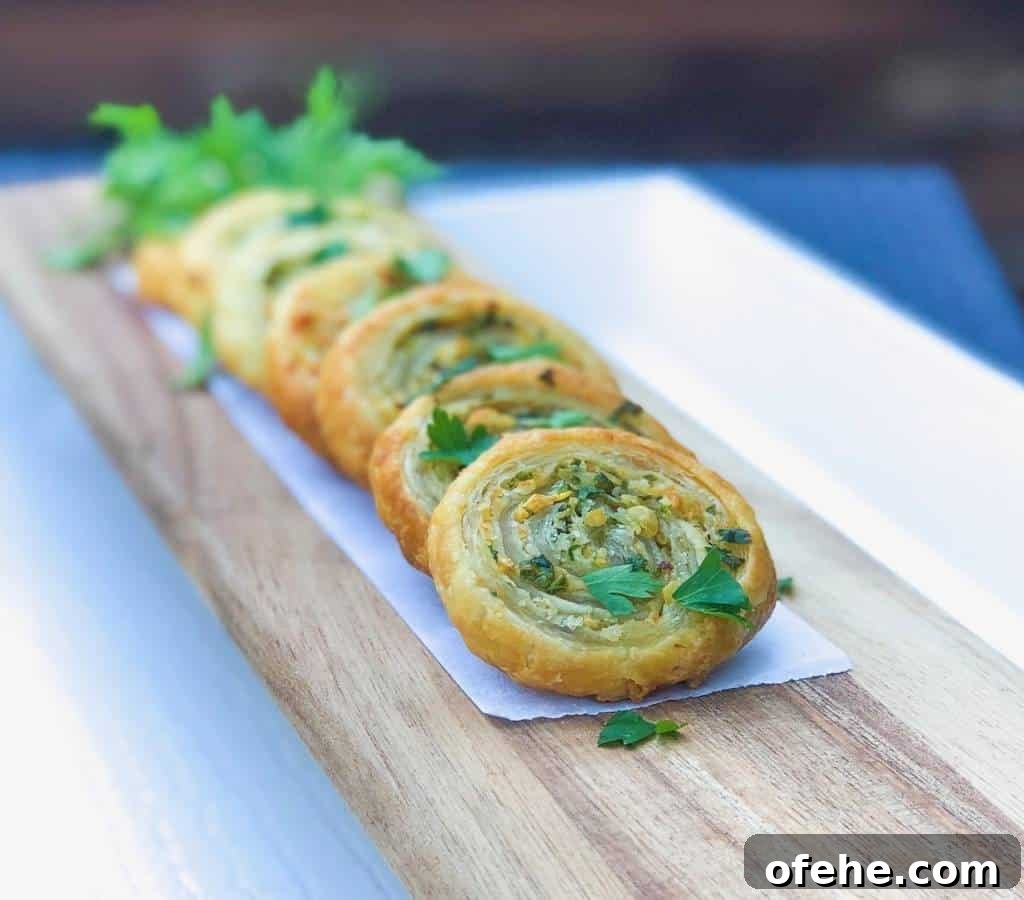 puff pastry pinwheels with parsley on top.
