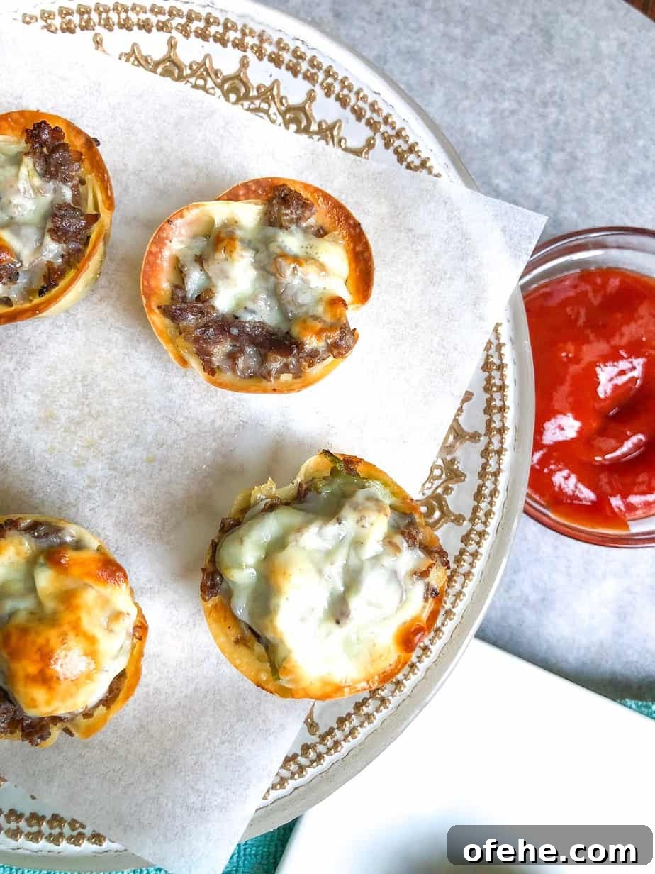 cheese steak wonton cups on a plate with ketchup on the side.