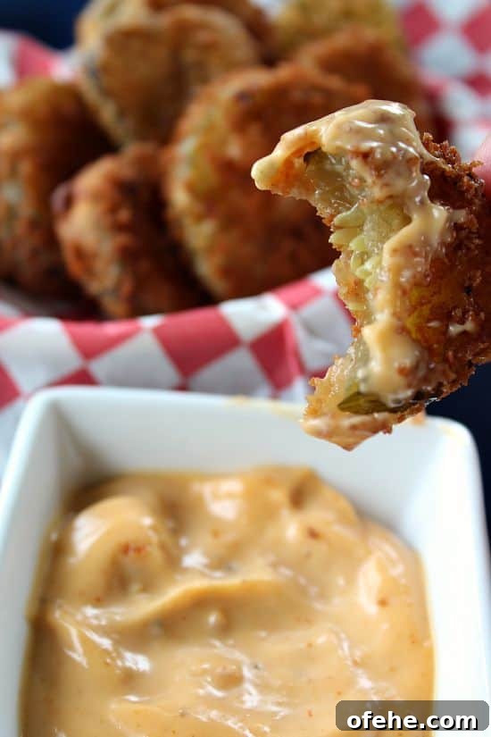 fried dill pickles with a bite taken out.