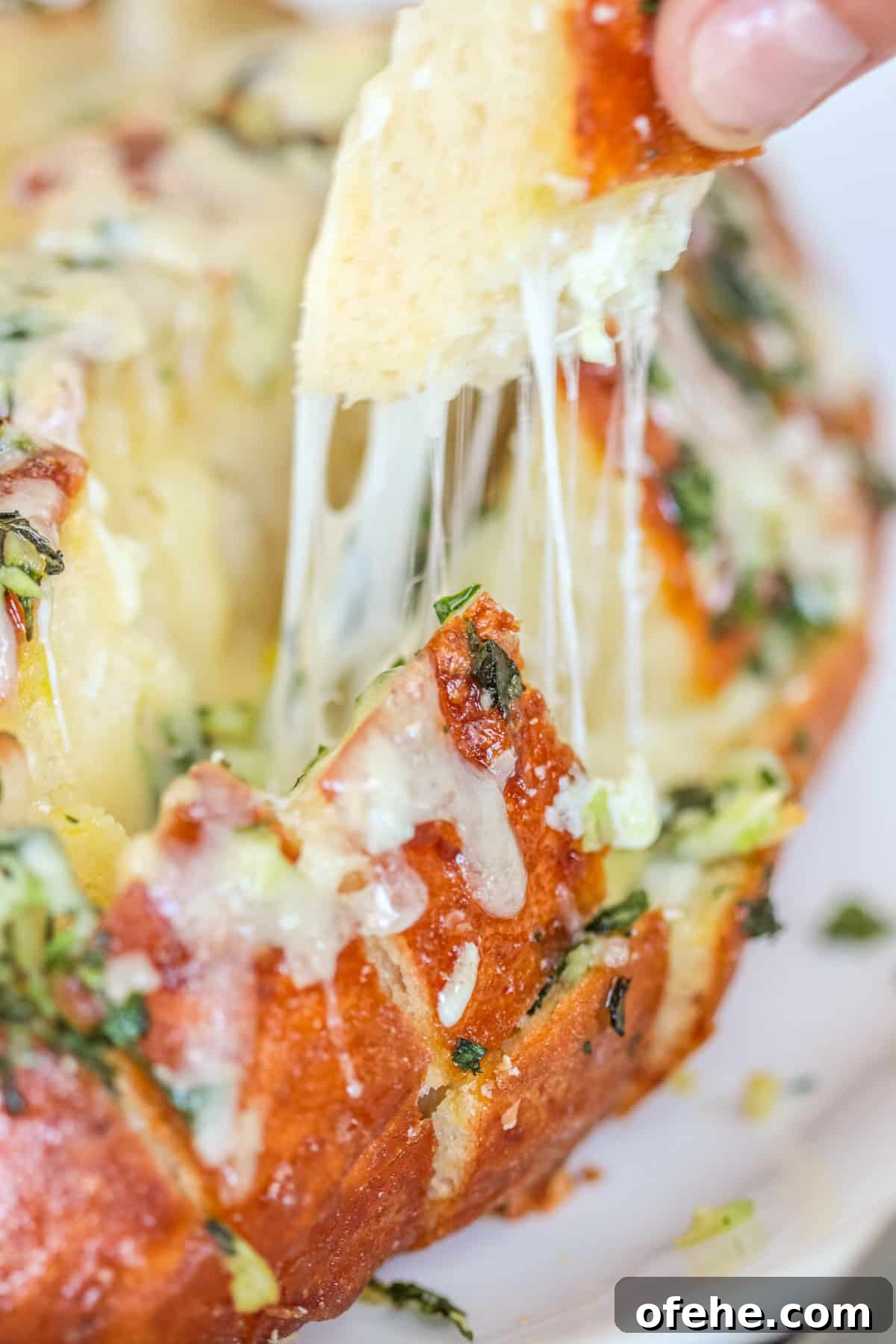 Bread with cheese pulling apart.
