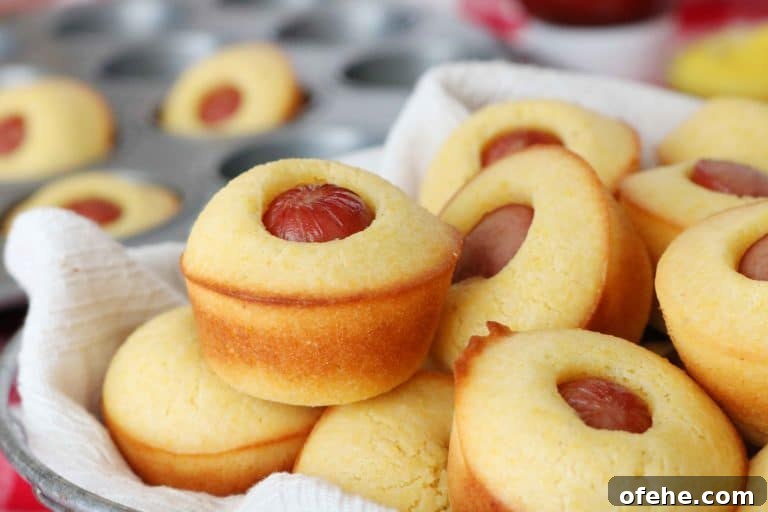 mini corn muffins stuffed with a hot dog in the middle.