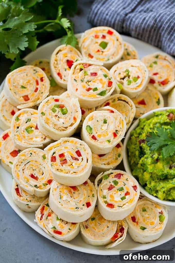 tortilla wraps spread onto a platter with guacamole on the side.