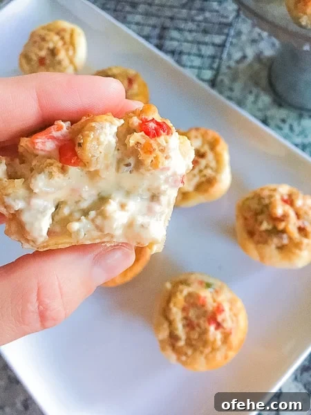 sausage stuffed biscuits with cheese oozing out.
