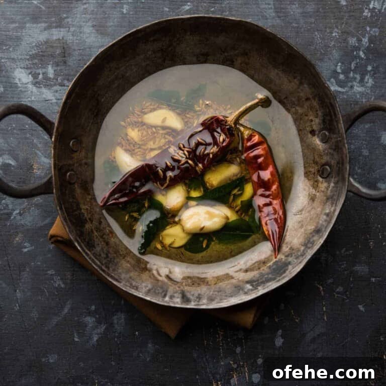 Indian Tadka: Mastering the Art of Tempering Spices 2 indian tadka in large metal wok