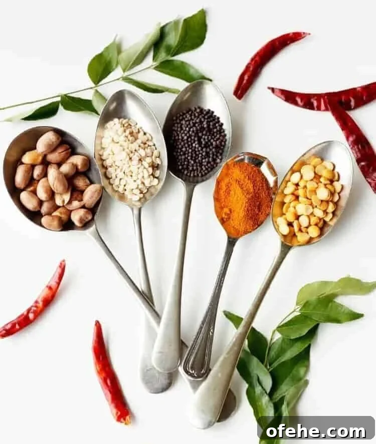 Indian Tadka: Mastering the Art of Tempering Spices 5 5 spoons, each holding a different whole Indian spice