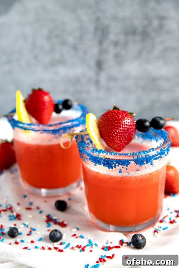 Two glasses of red white and blue 4th of July Strawberry Lemonade Cocktail