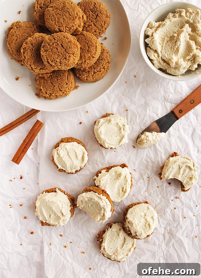 Soft Pumpkin Cookies with Cashew Frosting — Gluten-Free Recipe 2 Soft pumpkin cookies with cashew frosting - Pillow-y soft pumpkin cookies topped with cashew frosting that tastes like buttercream. The perfect dessert recipe for fall or the holidays, especially Thanksgiving! (Gluten free and Dairy Free) | robustrecipes.com