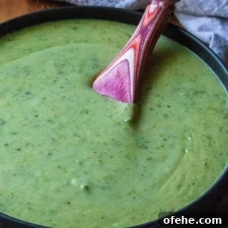 Creamy Roasted Garlic Poblano Sauce is made easy with roasted poblanos peppers, jalepenos and garlic. Made by roasting poblanos in the oven, this Creamy Roasted Garlic Poblano Sauce is perfect for enchiladas, tacos, quesadilla or as a rich dipping sauce for just about anything you love.