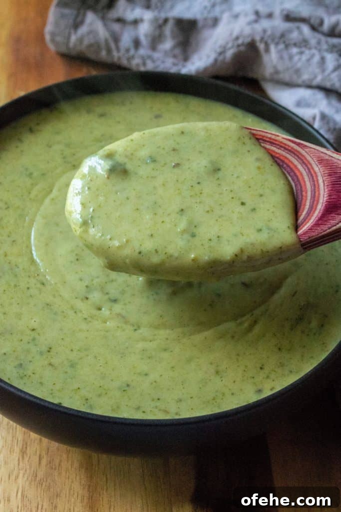 Creamy Roasted Garlic and Poblano Sauce Recipe 5 Creamy Roasted Garlic Poblano Sauce on a spoon | A Wicked Whisk