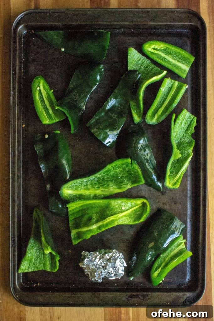 Creamy Roasted Garlic and Poblano Sauce Recipe 7 Creamy Roasted Garlic Poblano Sauce peppers on a sheet pan | A Wicked Whisk