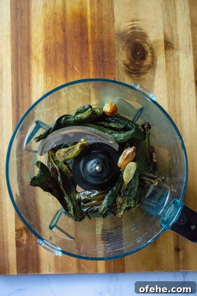 Creamy Roasted Garlic and Poblano Sauce Recipe 8 Creamy Roasted Garlic Poblano Sauce roasted peppers in a food processor | A Wicked Whisk